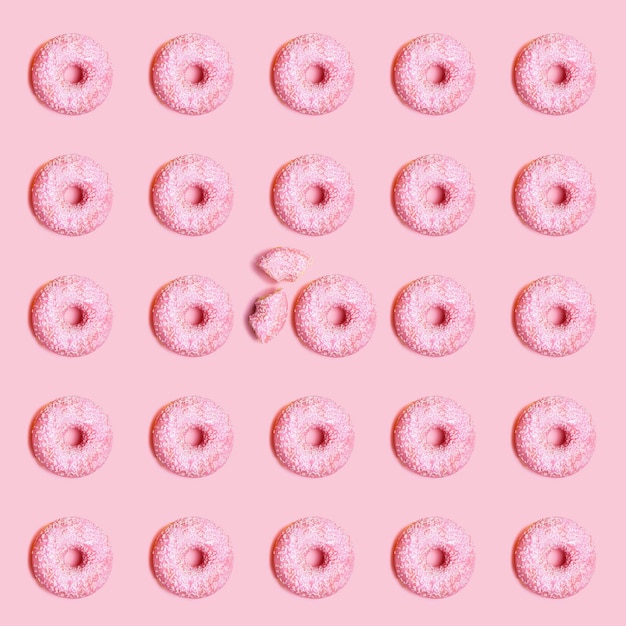 Patrón sin fisuras de donut rosa con fondo rosa