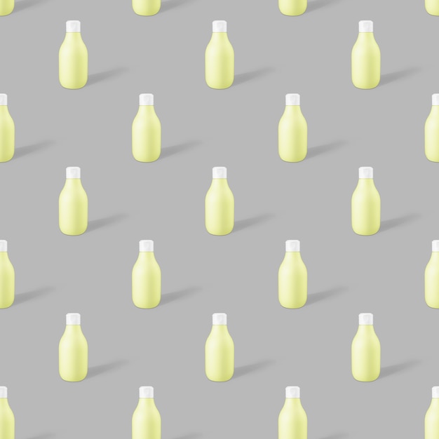 Patrón sin fisuras de maqueta de botella cosmética de plástico biodegradable amarillo sobre un fondo gris de moda. Foto conceptual