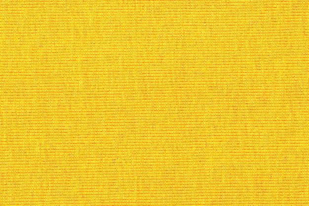 Patrón de fondo de textura de géneros de puntoDetalle de un cálido suéter de inviernoColor amarillo