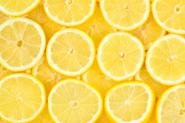 Un patrón de fondo de textura de limones amarillos jugosos frescos