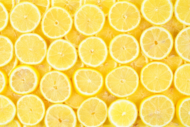 Un patrón de fondo de textura de limones amarillos jugosos frescos