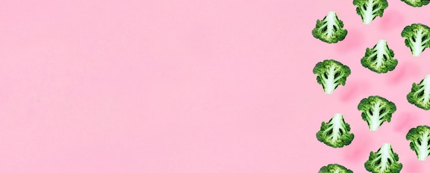 Patrón minimalista sin costuras con brócoli sobre un fondo rosa