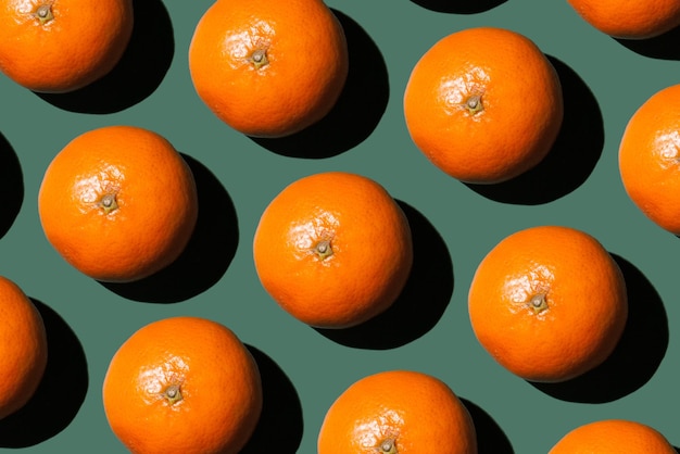 Foto patrón de navidad naranja mandarinas sobre fondo verde