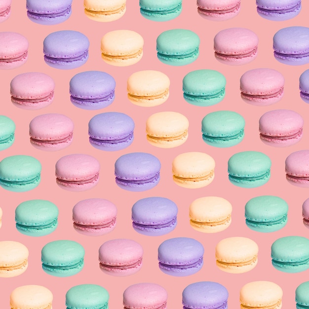 Patrón repetitivo con macaron sobre fondo rosa