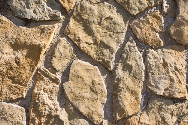 Foto patrón de textura y fondo de pared de piedras astilladas