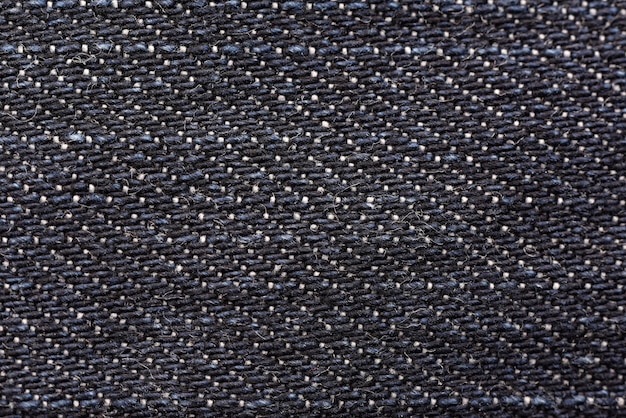 Patrón de textura de jeans de mezclilla, Primer plano de fondo de detalle de tela de jeans azul oscuro.