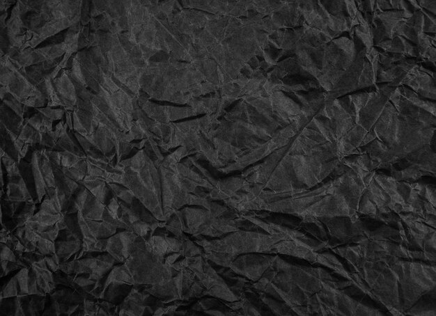 Foto patrón de textura de papel arrugado negro grunge áspero en blanco viejo