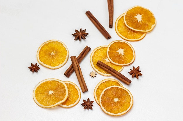 Paus de canela anis estrelado e lascas de laranja em branco