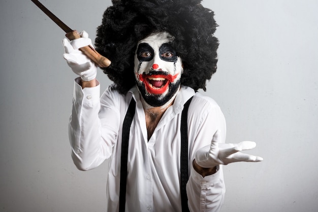 Payaso asesino con cuchillo haciendo gesto de sorpresa en textura espalda