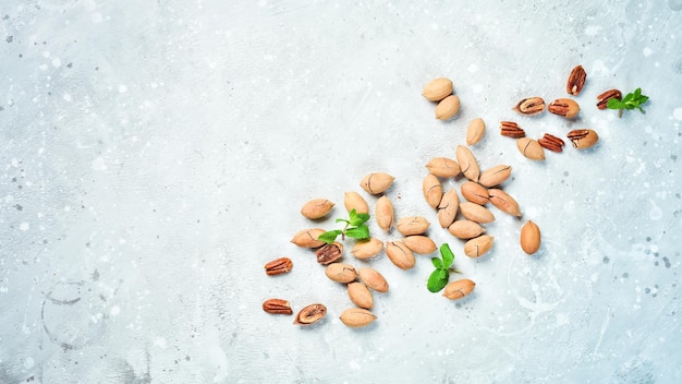 Pecans com casca em um fundo de pedra Variedade de nozes Vista superior