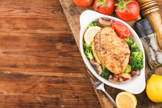 Foto pechuga de pollo a la plancha con verduras en un plato