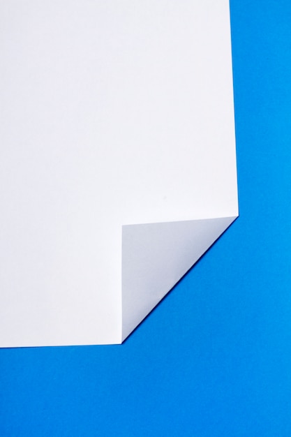 Pedaço de papel branco sobre um fundo azul.