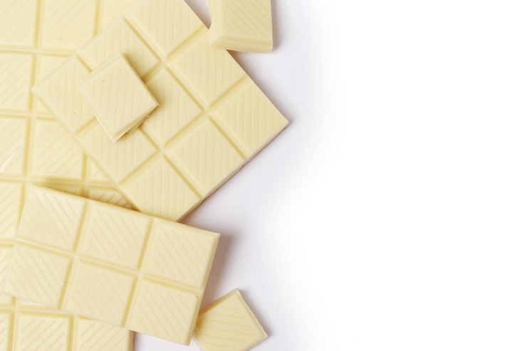 Foto pedaços de chocolate branco isolados em um fundo branco.