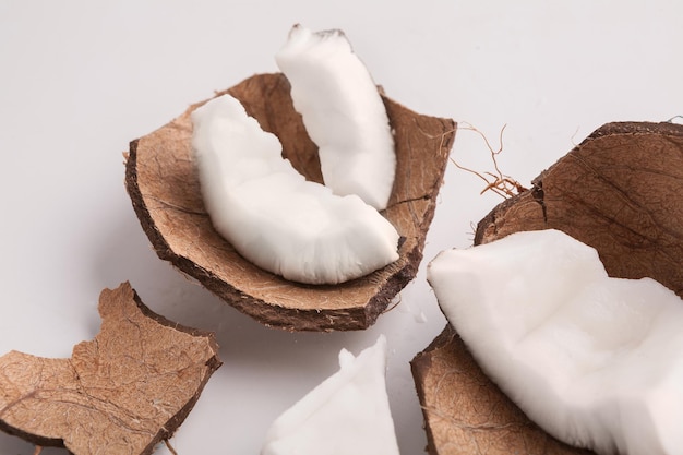 Pedazos de coco en cáscara aislado sobre un fondo blanco, primer plano, espacio de copia. Fruta, comida, concepto sabroso. Nueces exóticas nutritivas.