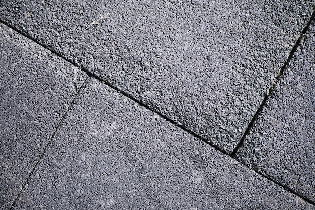 Pedra de pavimentação cinza, passarela para pedestres, pavimentação perto, a textura, vista superior. Fundo de piso de pedra quadrada de tijolo de cimento. Lajes de pavimentação de concreto. Lajes para pavimento