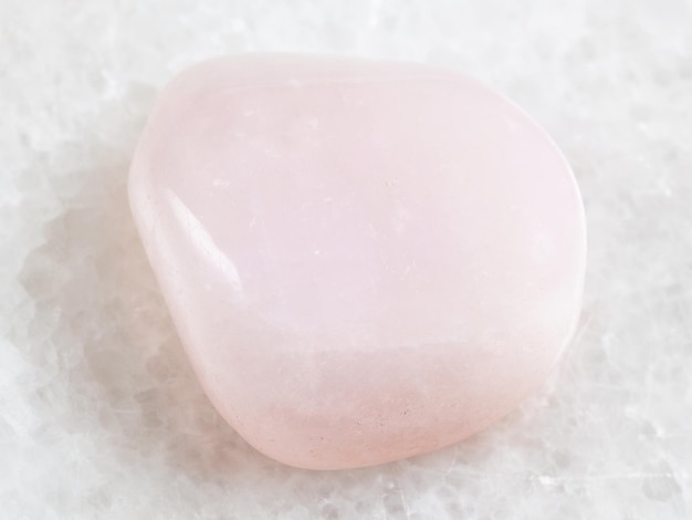 Pedra preciosa de petalita rosa caída em branco