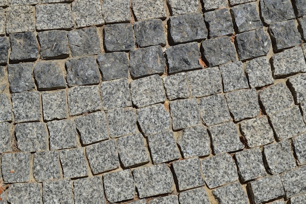 Pedras de granito quadrado fundo cinza forrado o caminho na calçada