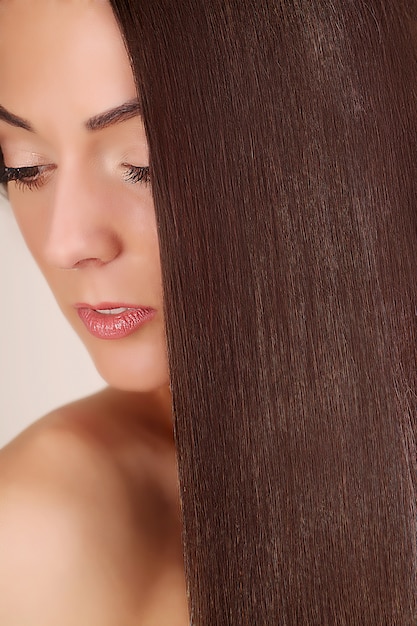 Pelo. Retrato de mujer hermosa con cabello largo castaño.