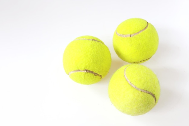 Pelotas de tenis sobre fondo blanco, bolas verdes deportivas aisladas. primer plano del equipo