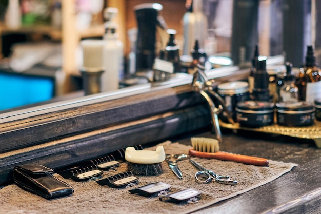 Peluquería herramientas de corte de pelo equipo de peluquero en la parte delantera de la encimera de madera del espejo antiguo interior vintage