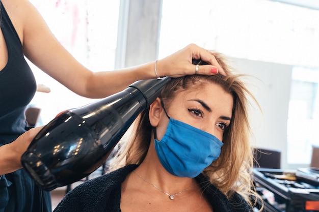 Peluquero secando el cabello de un cliente