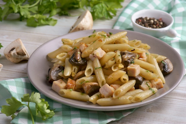 Penne pasta con champiñones y pollo en gris