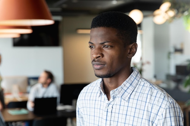Pensativo jovem empresário afro-americano no escritório criativo