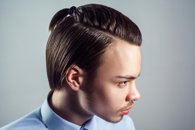 Penteado masculino, moda beleza em fundo cinza