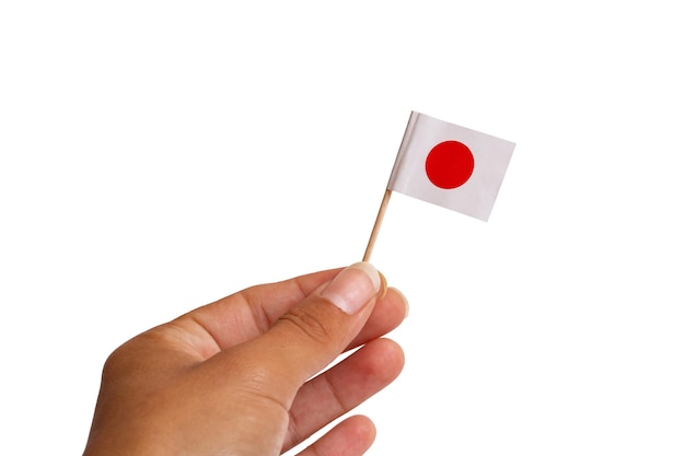 Pequena bandeira japonesa à disposição isolada no fundo branco