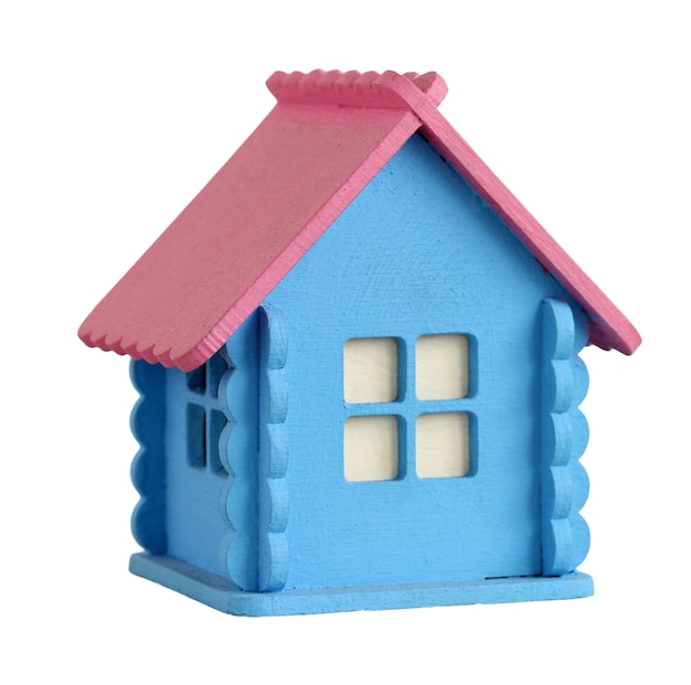 Pequeña casa de madera con techo rosado aislado sobre fondo blanco Casa de madera en miniatura colorida que representa el concepto de hogar, familia, bienes raíces o construcción