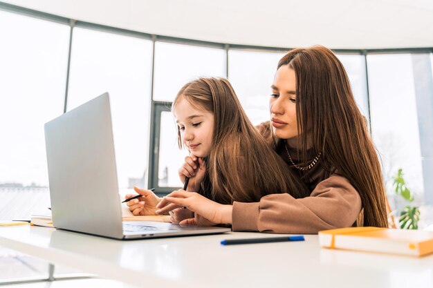 Pequeña colegiala en el aprendizaje a distancia en casa