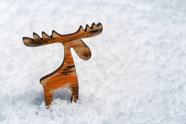 Pequena figura de madeira de veado na neve com espaço vazio conceito para ano novo ou feliz Natal