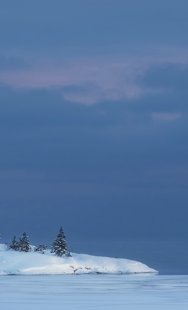 Pequeña isla cubierta de nieve en el lago de invierno Ladoga en Karelia en el estilo del minimalismo