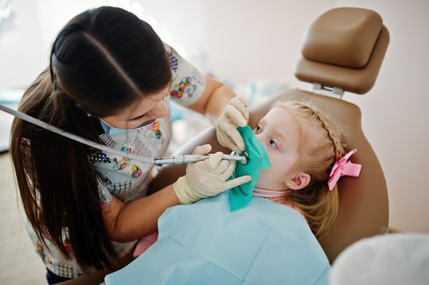 Pequeña niña en la silla del dentista