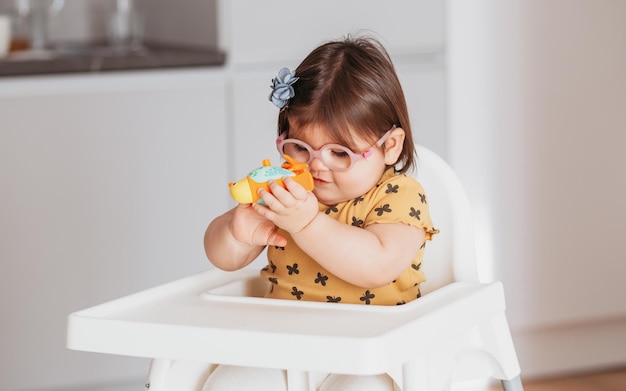 pequeña niña usaba anteojos jugando con juguetes