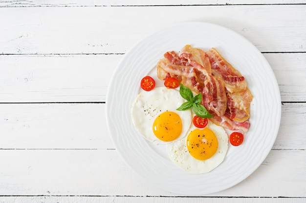 Pequeno-almoço inglês - ovo frito, tomate e bacon.