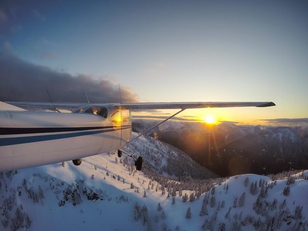 Pequeno avião voando por cima da bela paisagem montanhosa canadense