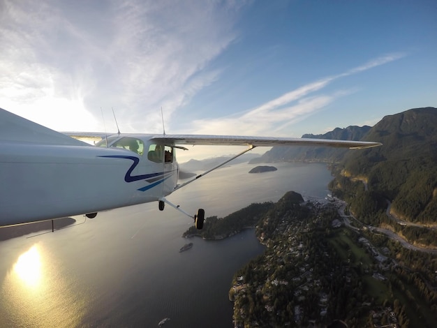 Pequeño avión volando por el hermoso paisaje de Howe Sound