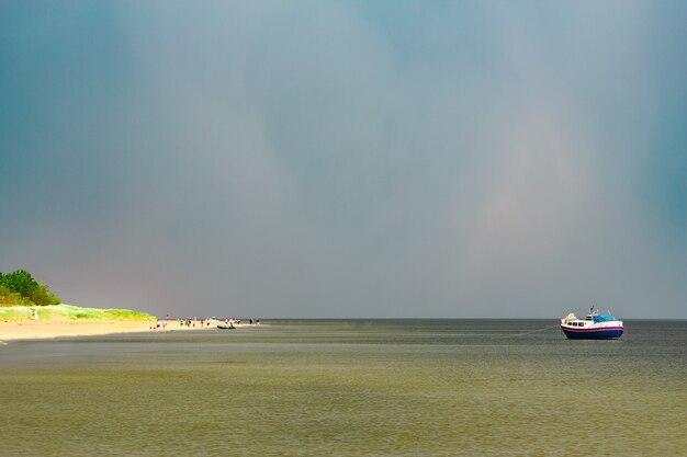 Pequeño barco de pasajeros azul amarrado en la bahía del mar Báltico