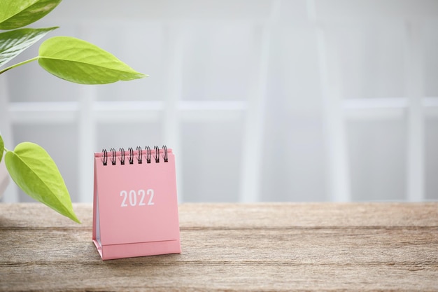 Pequeño calendario rosa con hojas verdes