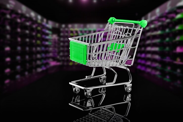 Foto pequeño carrito de compras sobre fondo negro