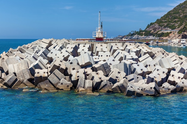Un pequeño faro con bloques de hormigón en la costa de Alanya. Faro en Alanya, Turquía