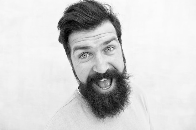 Percepciones de la belleza masculina Cuidado elegante de la barba y el bigote Cara feliz Moda de barba y peluquero Chico guapo de cerca Concepto de masculinidad Hombre barbudo hipster elegante barba fondo gris