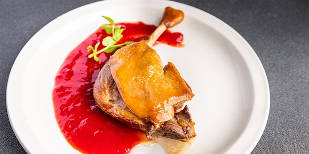 perna confitada de pato, lanche de comida de refeição de molho de frutas vermelhas na mesa copie o fundo de comida do espaço