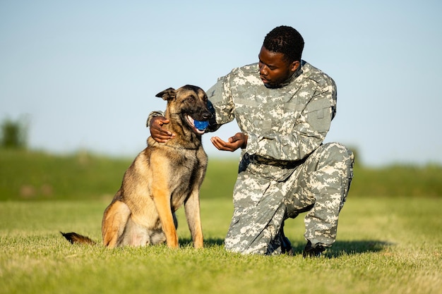 Perro militar y soldado jugando con pelota y construyendo su amistad