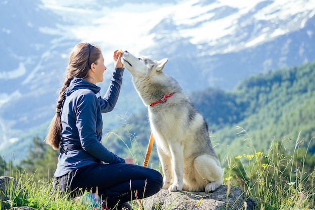 Perro con una mujer caminando montañas al aire libre