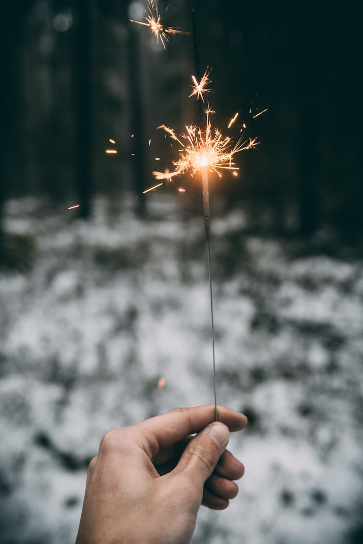 Foto person, die eine feuerwerksausstellung in der hand hält