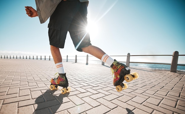 Person Rollschuhsport und Fitness auf einem Bürgersteig Meer oder Ozeanufer Sun Flare Übung und Sport mit Rollschuh-Cardio-Workout-Training für Wellness-Kraft und Gesundheit auf der Promenade