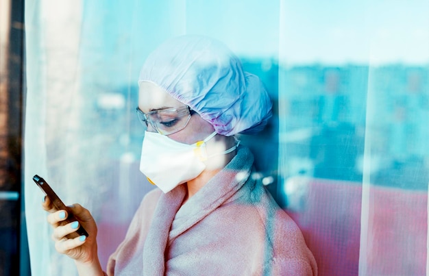 Persona infectada con covid19 está mirando por la ventana de un hospital