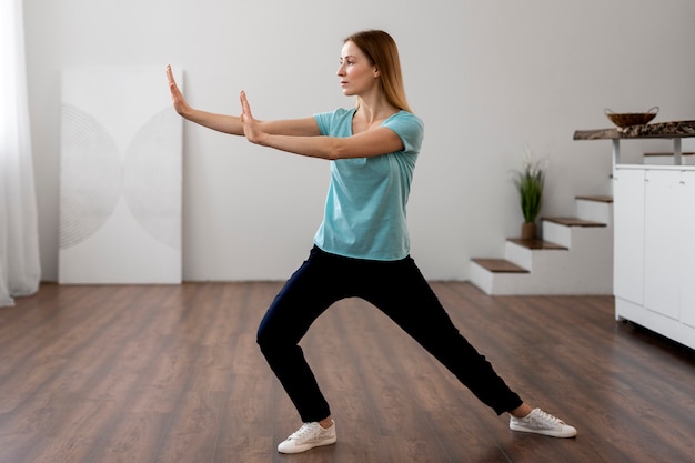 Foto persona practicando tai chi en interiores